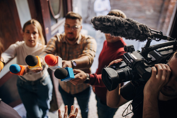 reporters with microphones