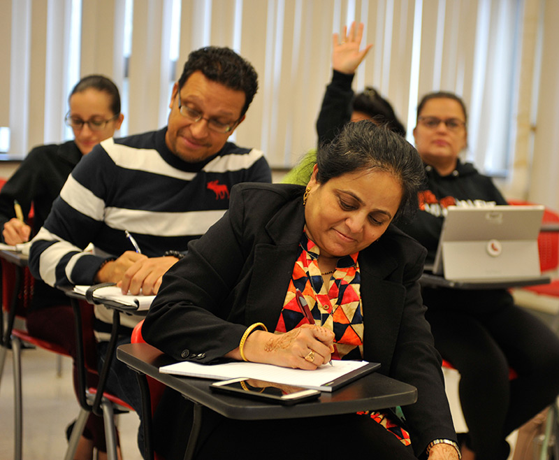 adult students writing at desks