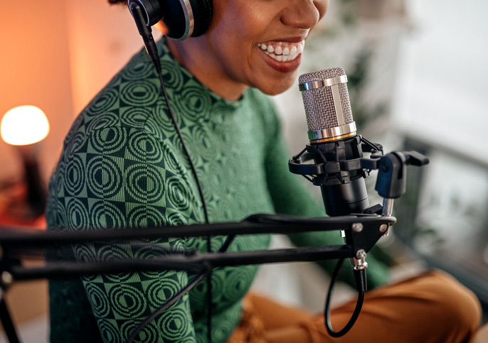 woman wearing a headset speaking into a microphone