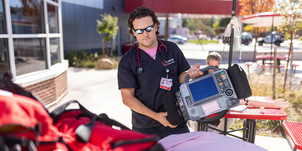 paramedic standing outside with gear