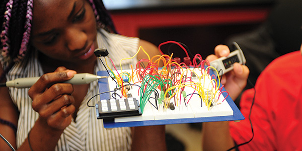 girl working on electronics board