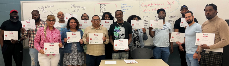 continuing education students holding up certificates